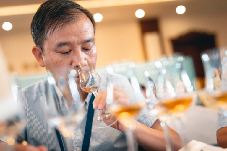 A judge smelling a glass of spirit