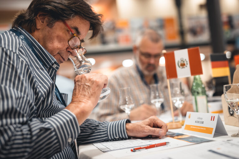 A man smelling a glass of spirit