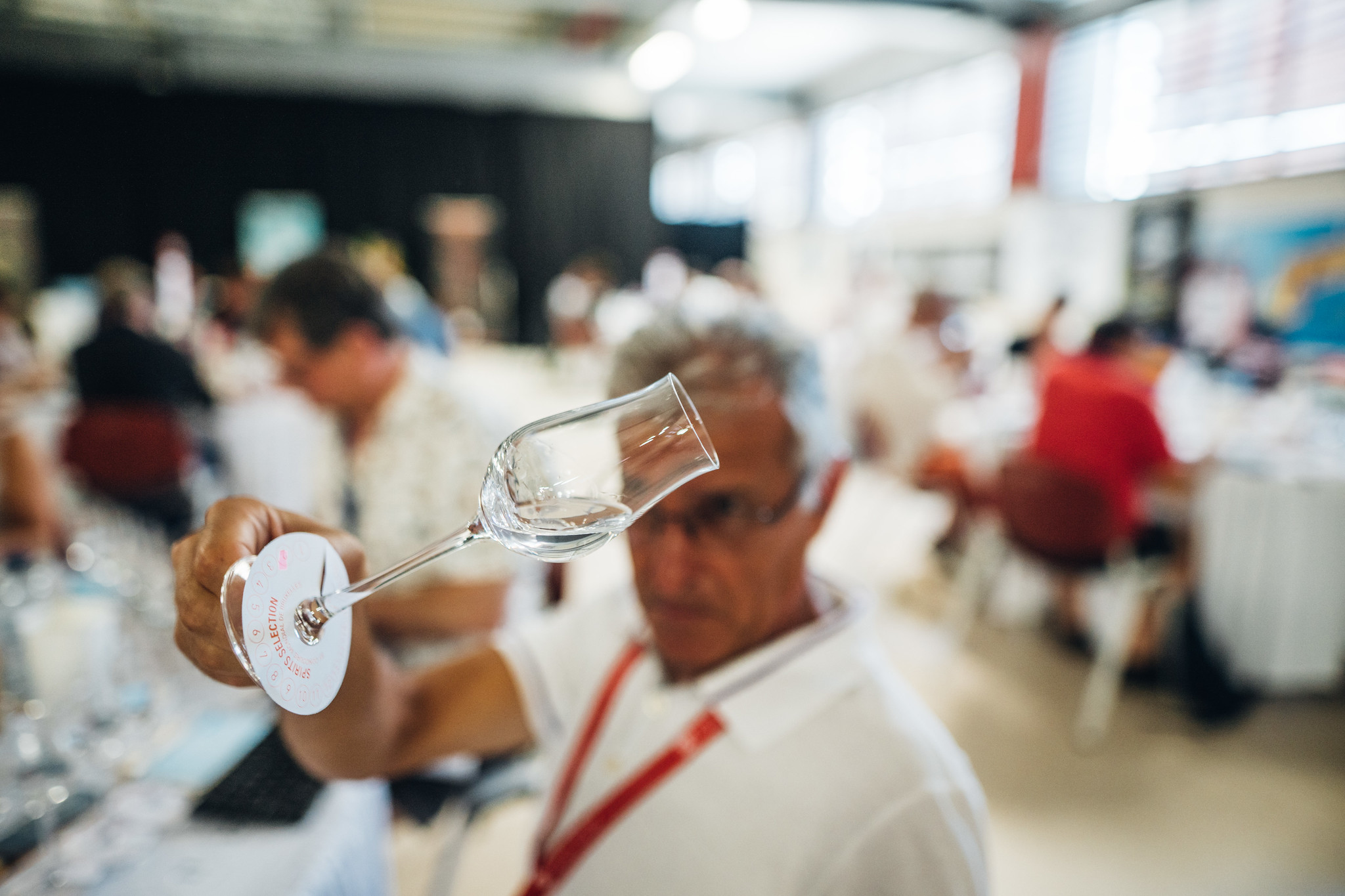 Man showing a glass at Spirits Selection competition